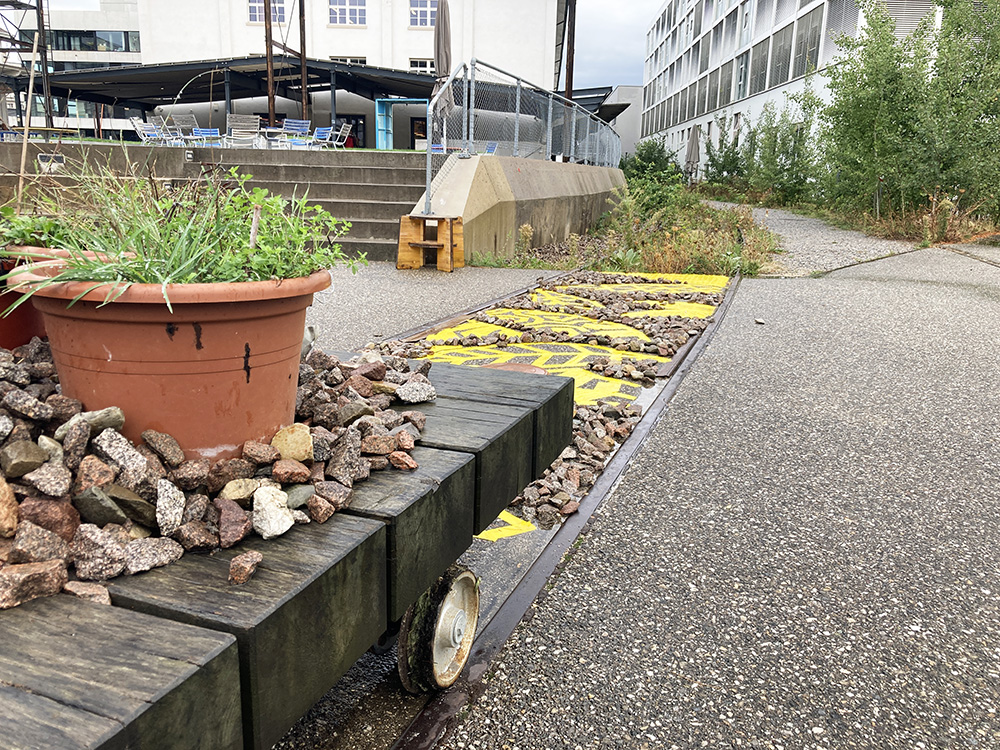 Design intervention by students on the HGK campus: “Networking Corridor” (2023), call for the renaturation of paved railroad tracks.